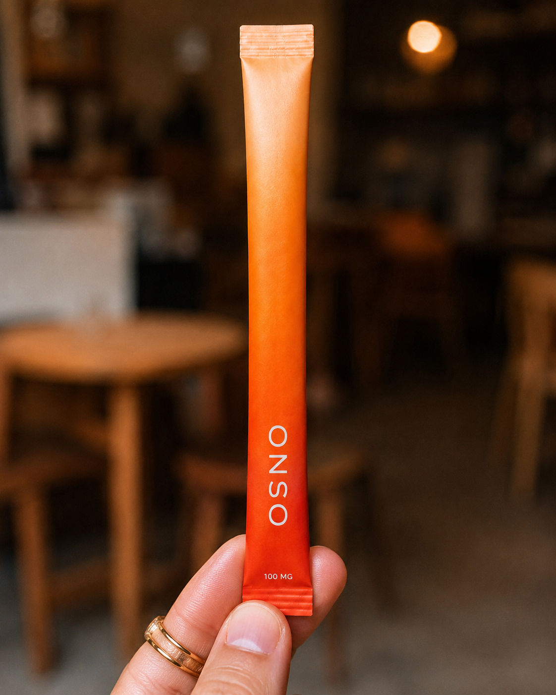 An ONSO stick held up in a cafe